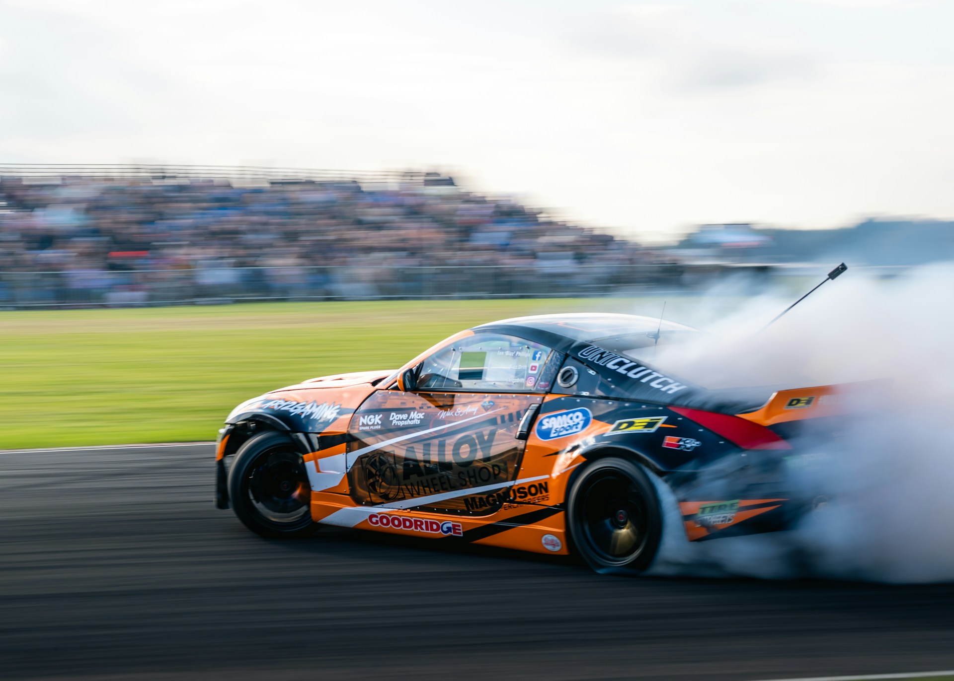 Smoke and speed: a race car mid-drift on the track. Photo by Jack Stapleton.